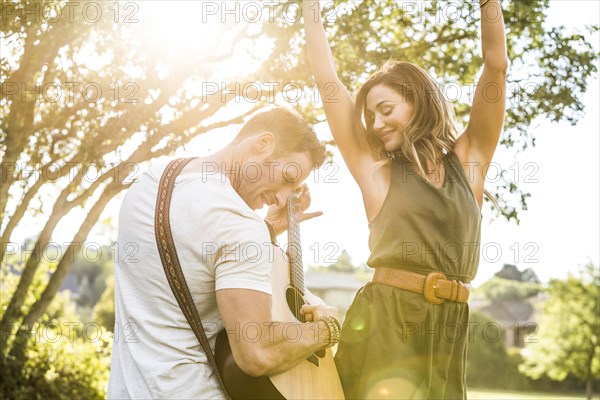 Romantic couple playing guitar and dancing