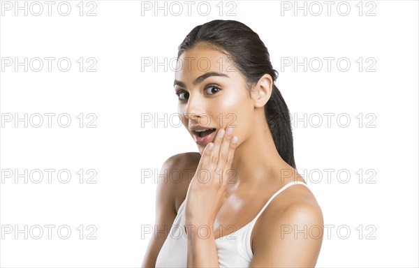 Portrait of surprised young woman looking at camera