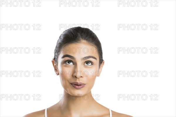 Portrait of young woman looking up