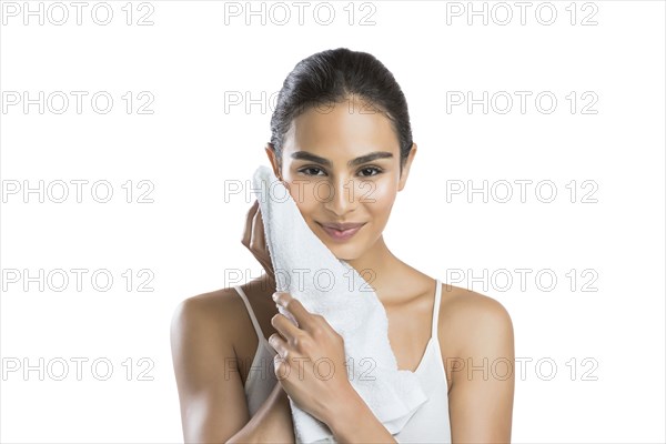 Portrait of smiling young woman with face towel