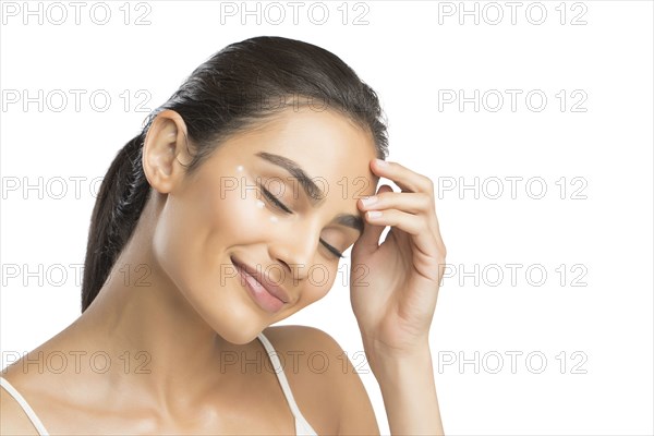 Portrait of smiling young woman with closed eyes