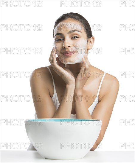 Portrait of young woman enjoying washing face