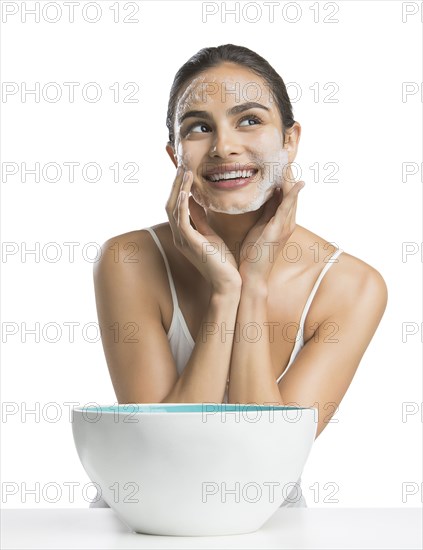 Portrait of young woman enjoying washing face