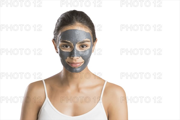 Portrait of young woman with facial beauty mask