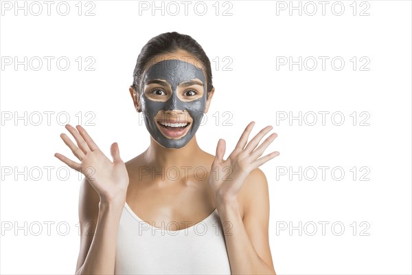 Portrait of young woman with facial beauty mask