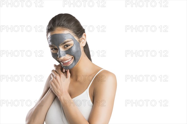 Portrait of young woman with facial beauty mask