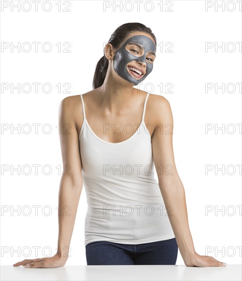 Portrait of young woman with facial beauty mask