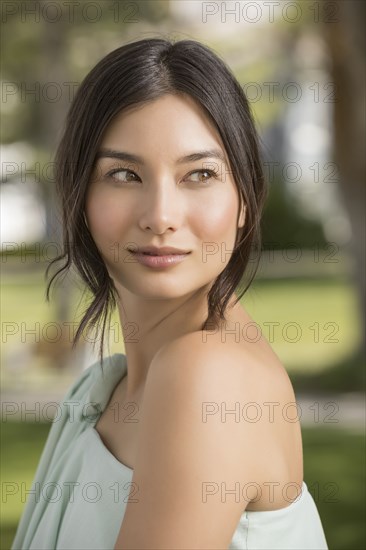 Portrait of beautiful woman looking away in park