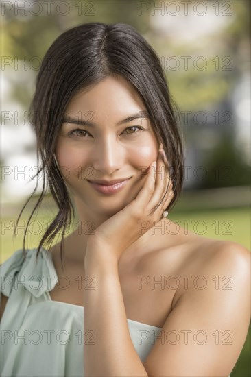 Portrait of beautiful woman looking at camera in park