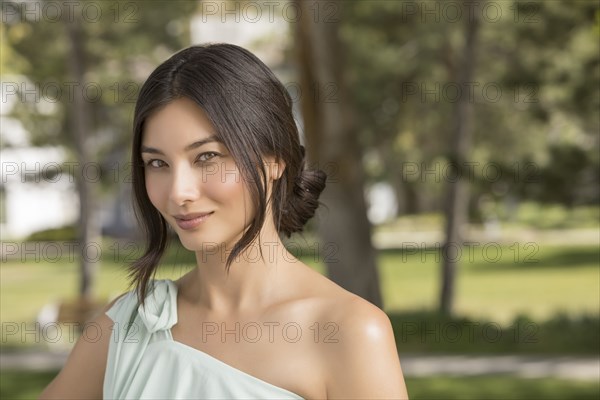 Portrait of beautiful woman looking at camera in park
