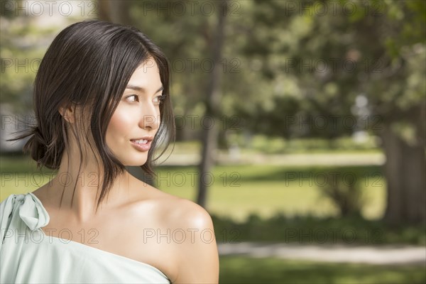 Portrait of beautiful woman looking away in park