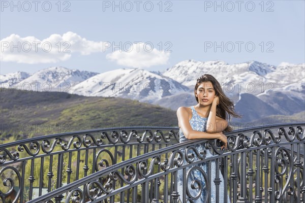 Portrait of beautiful woman on footbridge in mountain scenery