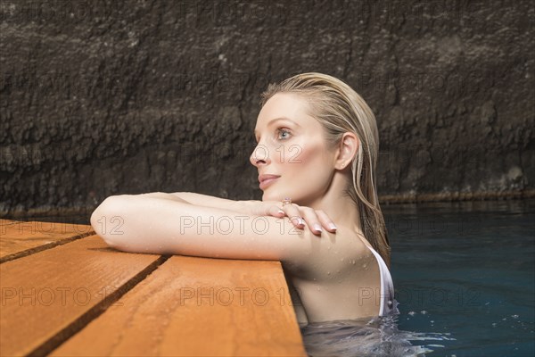 Beautiful woman relaxing in pond