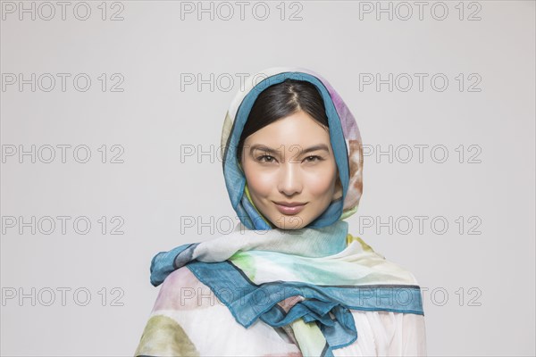 Studio portrait of beautiful woman wearing headscarf