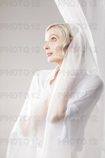 Beautiful woman wrapped in tulle fabric