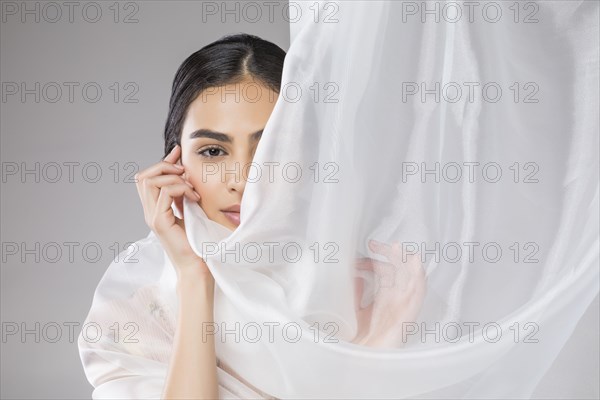 Beautiful woman wrapped in tulle fabric