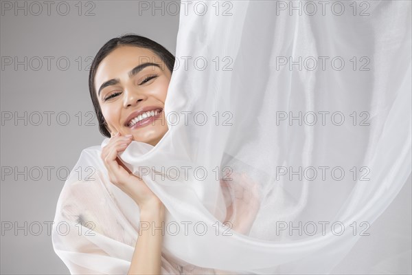 Beautiful woman wrapped in tulle fabric