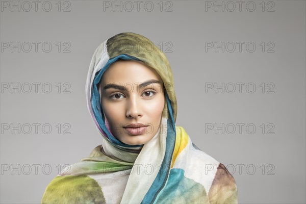 Studio portrait of beautiful woman wearing headscarf