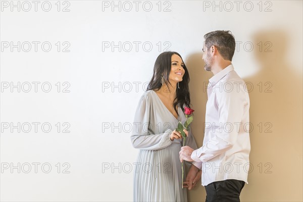 Man giving red rose to his girlfriend