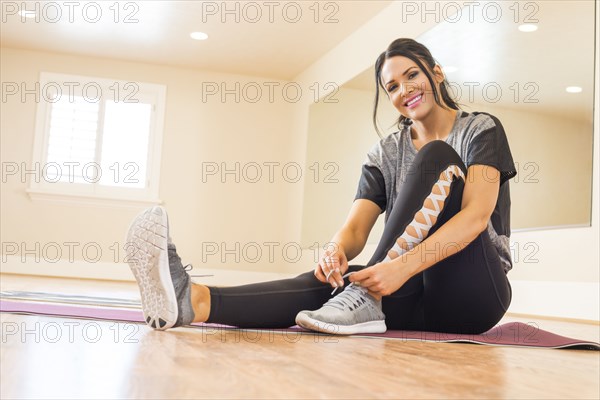 Woman sitting on floor in dance studio