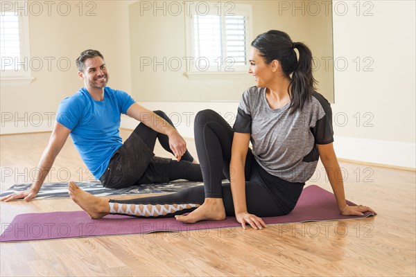 Happy couple resting in gym