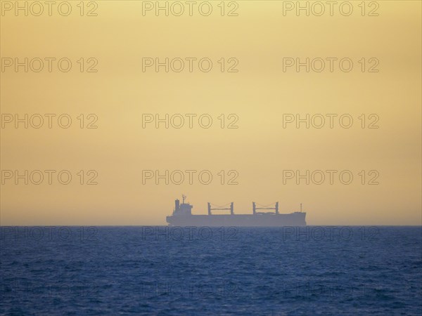 Container ship cruising on calm sea
