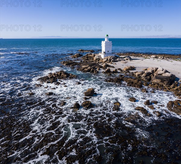 White lighthouse on coast of Atlantic Ocean