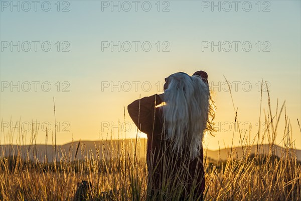 Senior woman looking at sunset