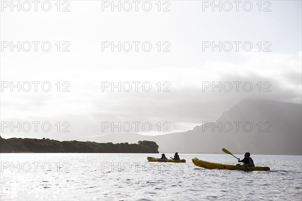 Kayakers kayaking in lagoon