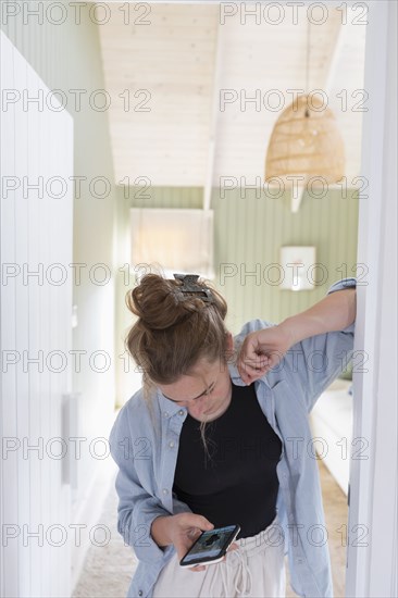 Teenage girl using phone in bedroom