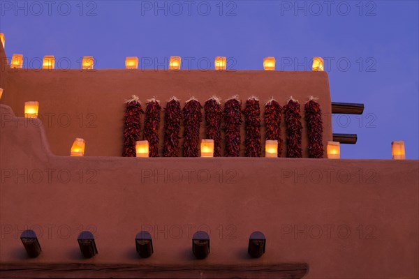 Traditional farolitos lanterns on adobe building