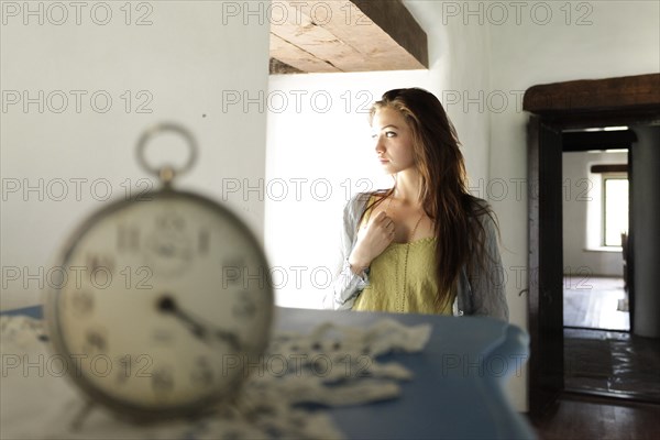 Young woman in old cottage