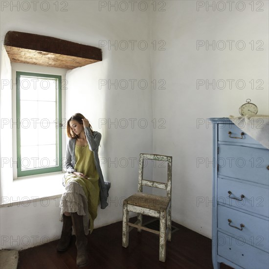 Young woman in old cottage