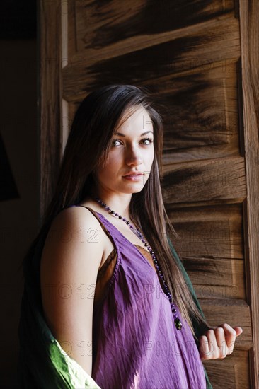 Portrait of young woman in doorway