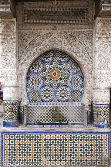 Traditional Moroccan tiled fountain in medina