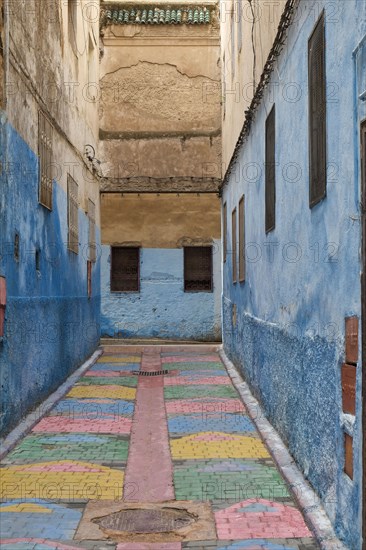 Colorful blue walls in alleyway in medina