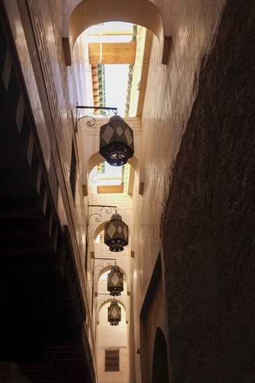 Low angle view of metal streetlamps in alley in medina