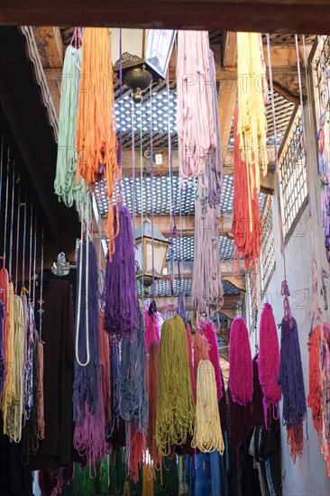 Colorful yarn hanging to dry after being dyed