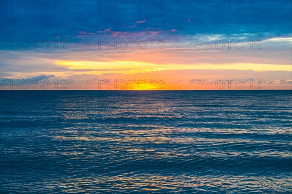 Sunset sky above calm ocean