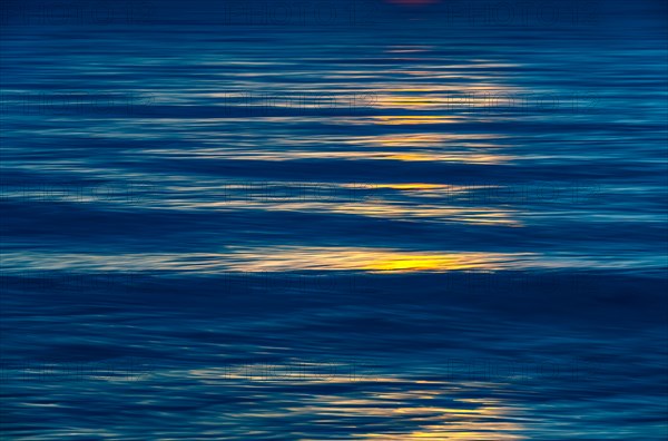 Sunlight reflected in calm water surface