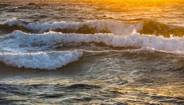 Close-up of sea waves reflecting sunlight