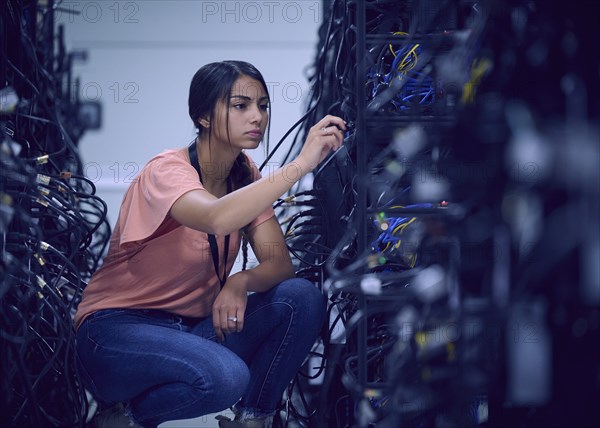 Female technician working in server room