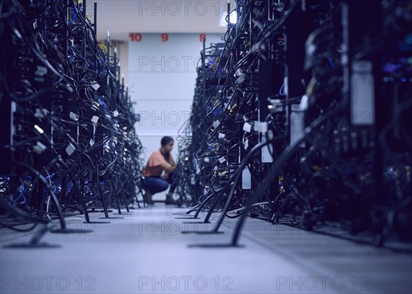 Female technician working in server room