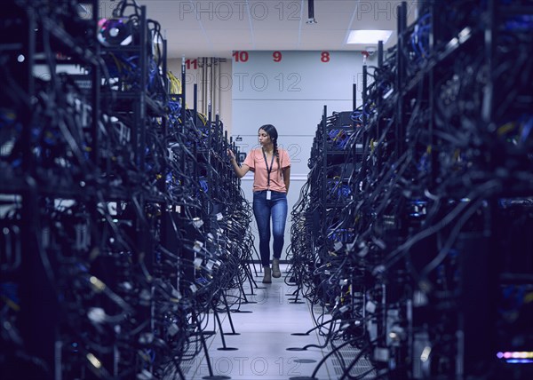 Female technician working in server room