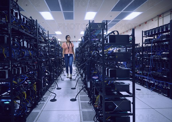 Female technician working in server room