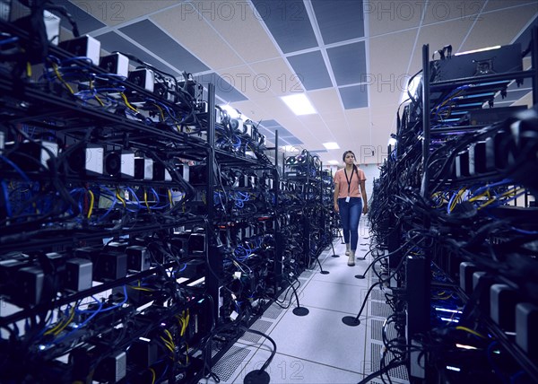 Female technician working in server room