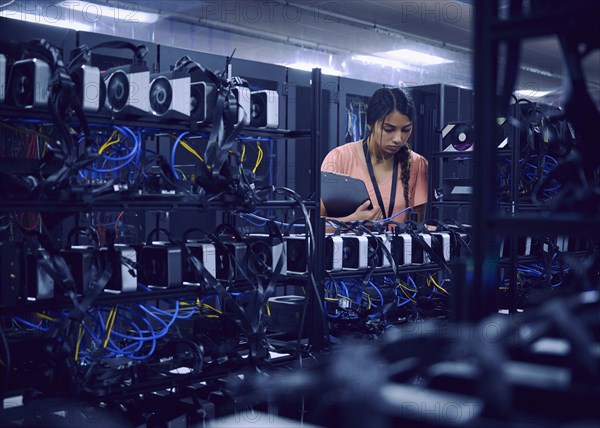 Female technician working in server room