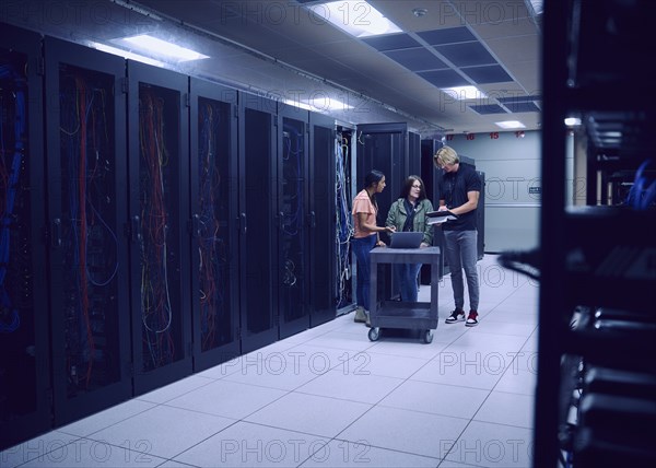 Team of technicians working in server room