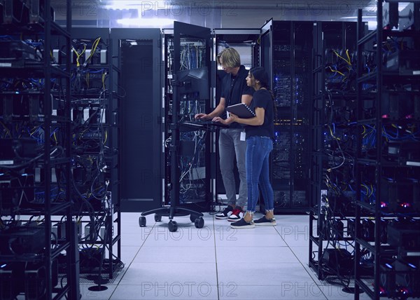 Technicians working in server room