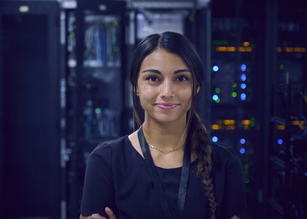 Portrait of smiling female technician in server room